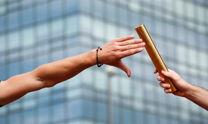 Close Up Of A Baton Exchanging Hands